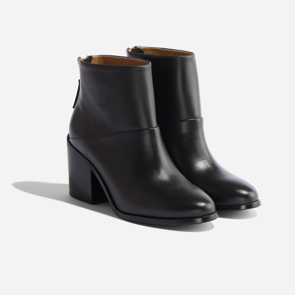 Pair of black leather ankle boots with a block heel and round toe, shown from a side angle on a white background.