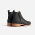 Pair of black leather Eva Everyday Chelsea boots with tan soles and elastic side panels on a white background.