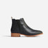 Single black leather Eva Everyday Chelsea boot with a brown stacked heel and elastic side panel.