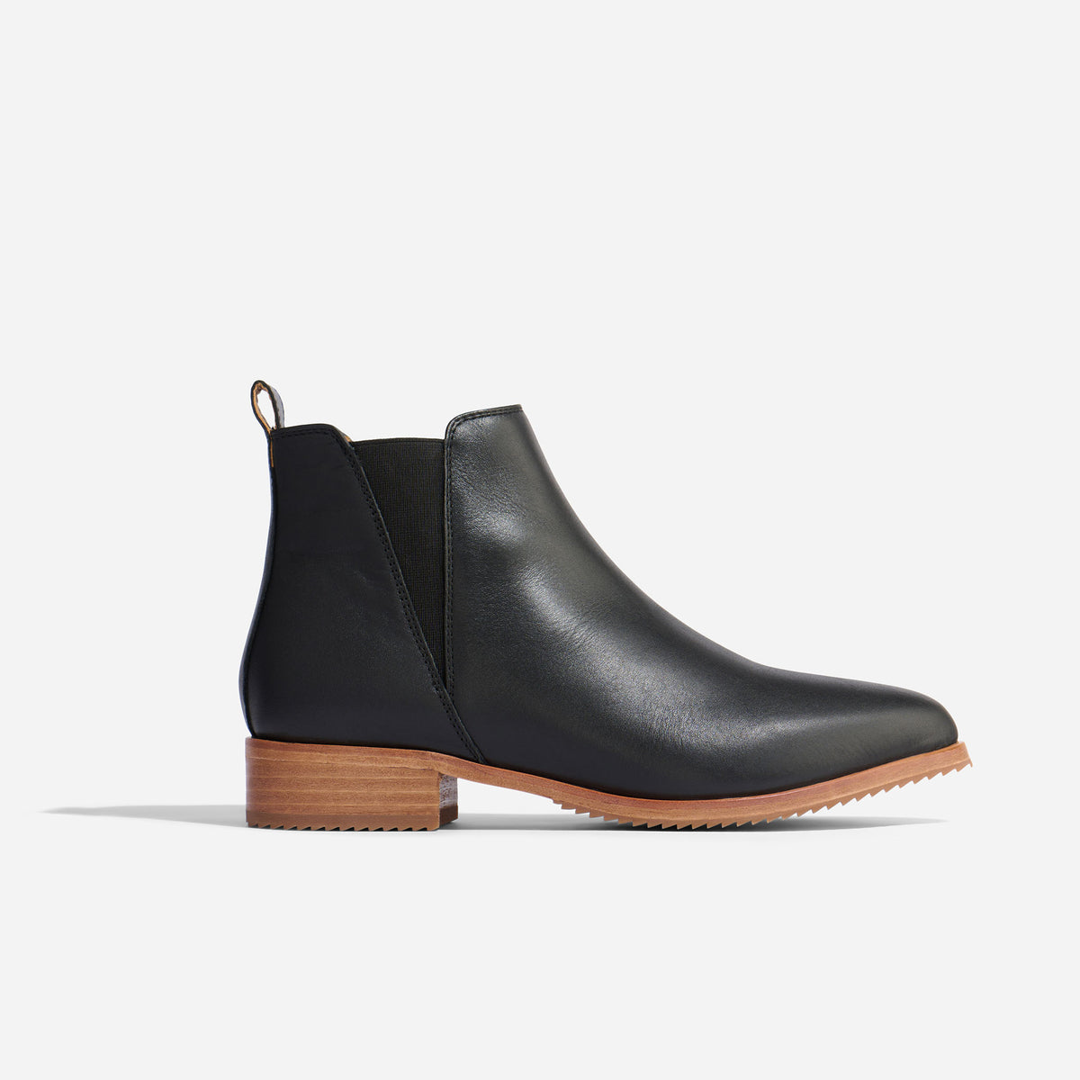 Single black leather Eva Everyday Chelsea boot with a brown stacked heel and elastic side panel.