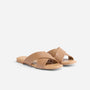 Pair of tan leather Catalina Slide Sandals with wide crisscross straps and flat soles on a white background.