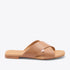Single almond leather slide sandal with two wide crisscross straps and NISOLO printed on the footbed.