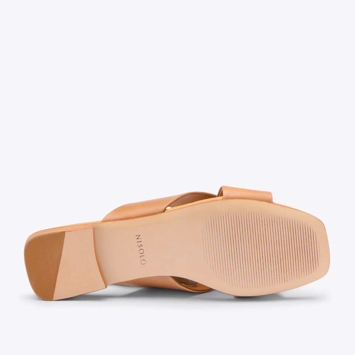 One tan leather slide sandal shown from the bottom, featuring a square toe and the NISOLO brand name on the sole.