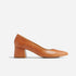 Single caramel leather pump with a rounded toe and a chunky mid-height block heel, shown from a side profile.