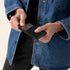 A person holds a black pebbled leather Nico Card Case while sliding out a silver credit card.