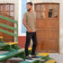 Man standing on green and yellow stairs wearing black leather Diego Everyday Sneakers with white soles.