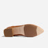 Sole of a caramel leather pointed-toe heel with a block heel and NISOLO printed on the tan arch.