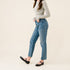 Pair of black leather Mary Jane flats worn by a person in blue jeans and a grey long-sleeve shirt.